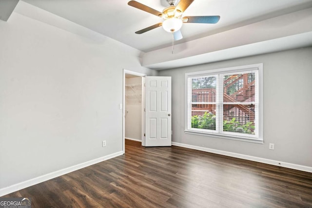 empty room featuring dark hardwood / wood-style floors and ceiling fan