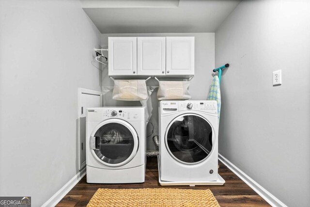 clothes washing area with independent washer and dryer, cabinets, and dark hardwood / wood-style floors