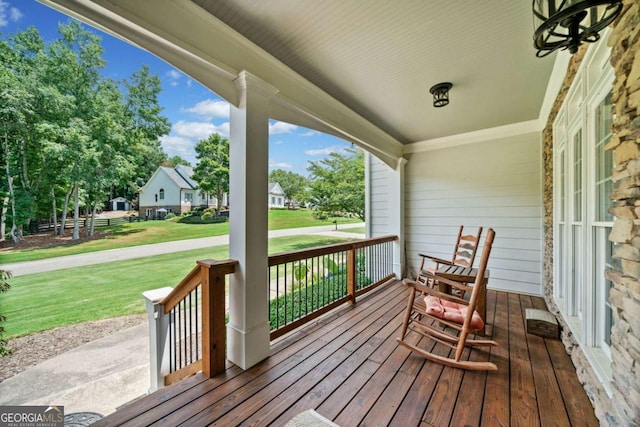 wooden terrace with a yard and a porch