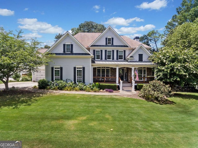 view of front facade featuring covered porch and a front lawn