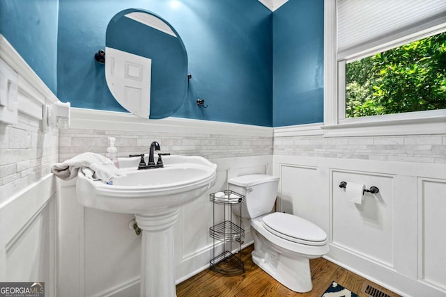 bathroom with hardwood / wood-style flooring and toilet