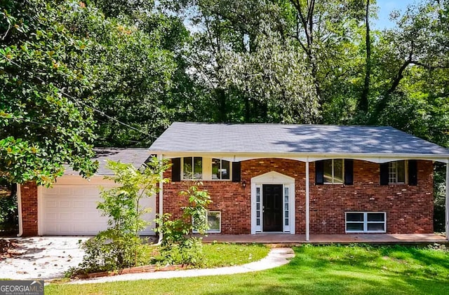 bi-level home featuring a garage and a front lawn