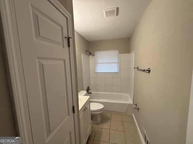 full bathroom with tile patterned flooring, vanity, tiled shower / bath, and toilet