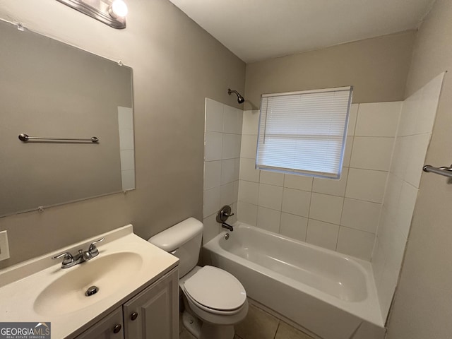 full bathroom featuring vanity, tiled shower / bath combo, tile patterned floors, and toilet