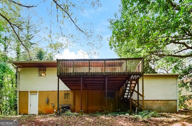 rear view of property with a wooden deck