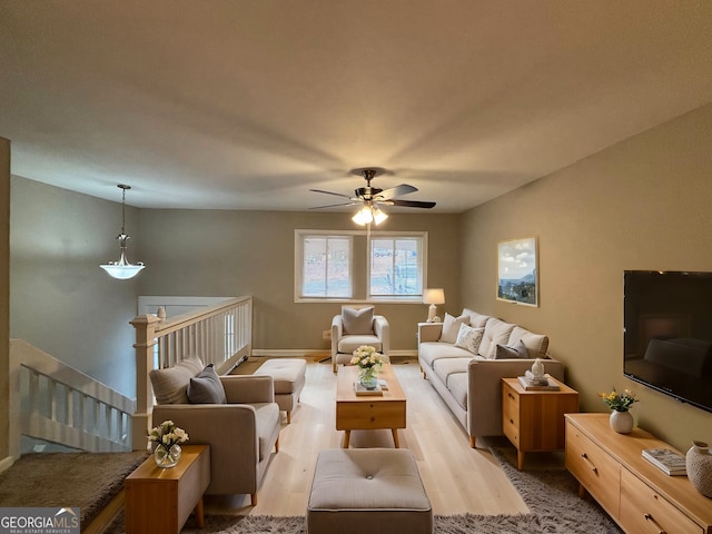 living room featuring ceiling fan and light hardwood / wood-style flooring