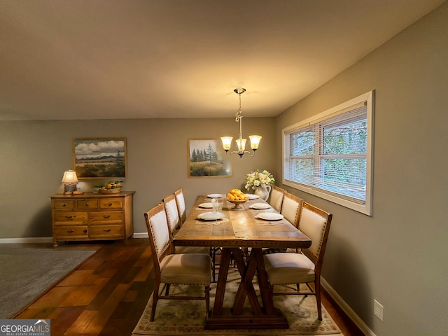 dining room featuring dark hardwood / wood-style flooring and an inviting chandelier