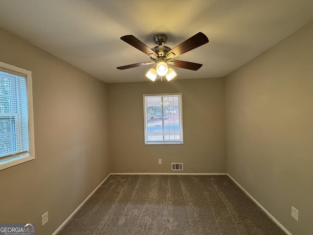 carpeted empty room featuring ceiling fan