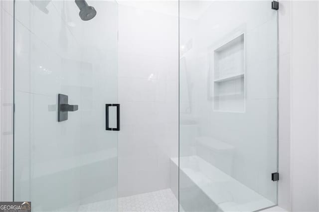 bathroom featuring a shower with shower door