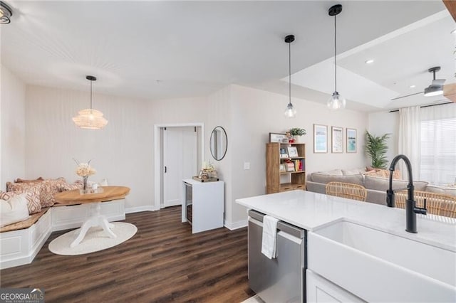 kitchen featuring sink, dishwasher, dark hardwood / wood-style floors, white cabinets, and decorative light fixtures