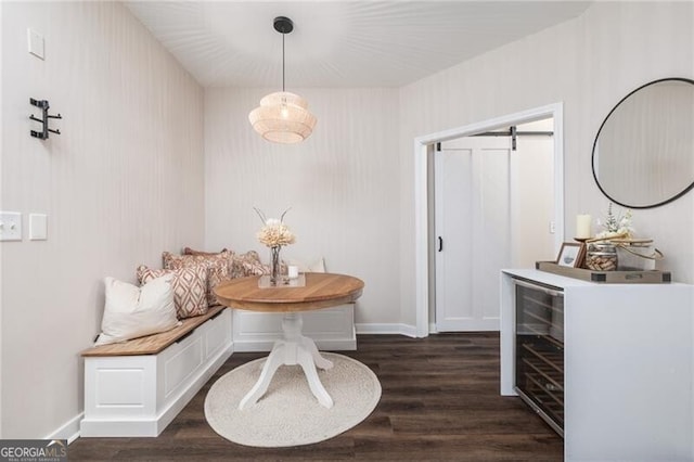 dining space with dark hardwood / wood-style floors and a barn door