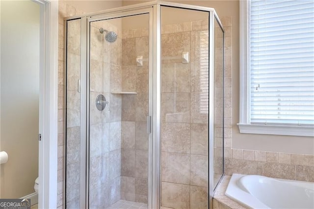 bathroom with toilet and plus walk in shower