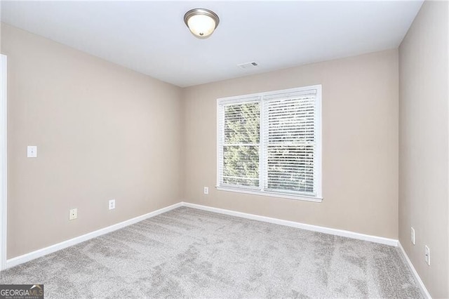 spare room with light colored carpet