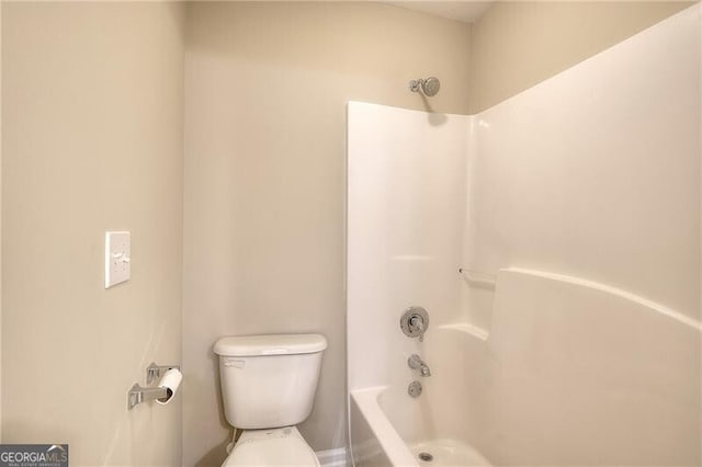 bathroom featuring toilet and shower / bathing tub combination