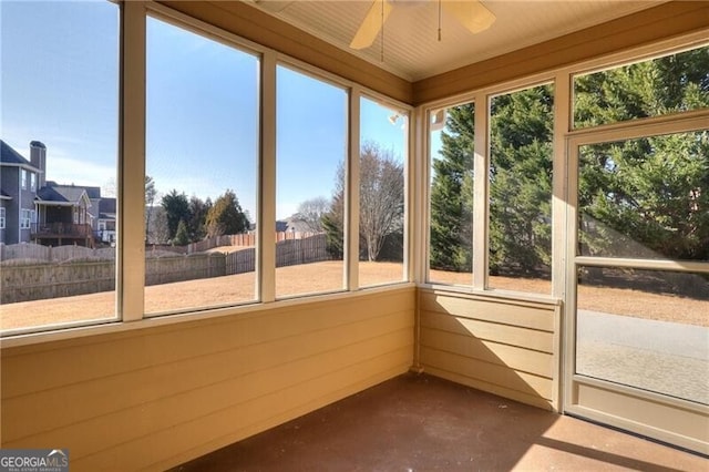 unfurnished sunroom with ceiling fan