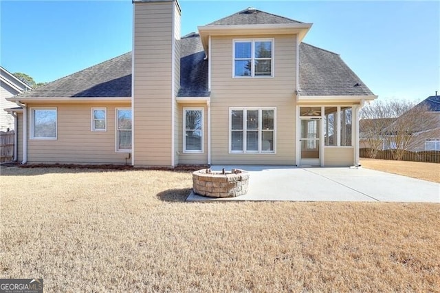 rear view of house featuring an outdoor fire pit, a lawn, and a patio area