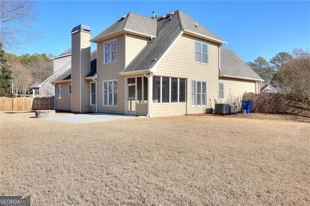 back of house featuring central AC, a sunroom, and a patio area