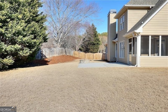 view of yard with a sunroom and a patio