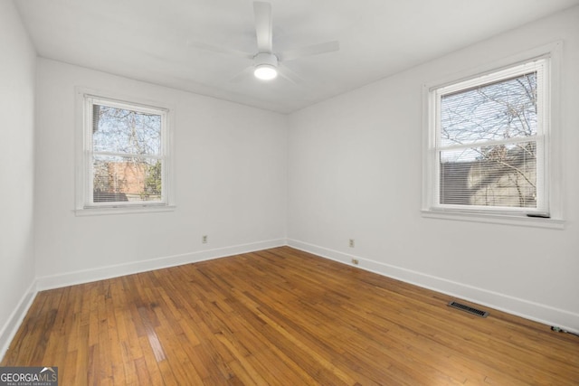 empty room with ceiling fan and wood-type flooring