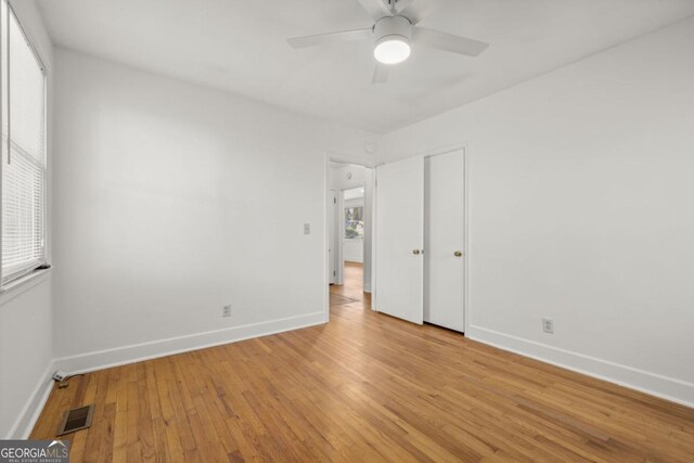 unfurnished bedroom with ceiling fan and light wood-type flooring