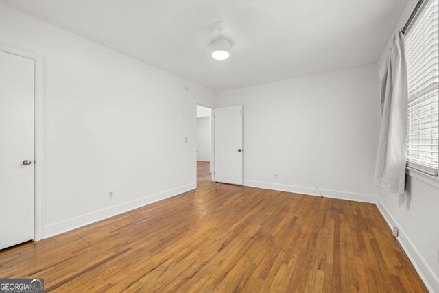 unfurnished room featuring hardwood / wood-style flooring