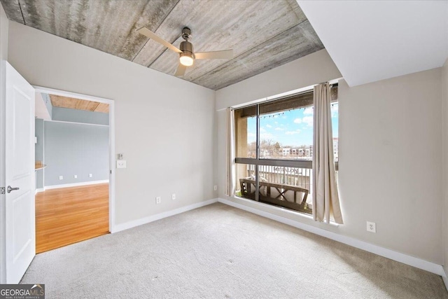 unfurnished room featuring ceiling fan, carpet, and baseboards