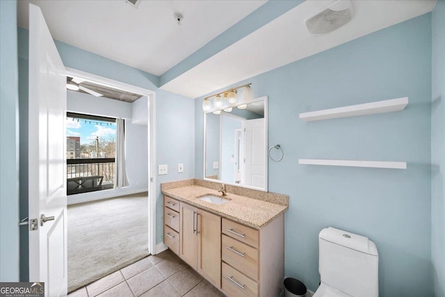 bathroom featuring toilet, tile patterned flooring, vanity, and visible vents