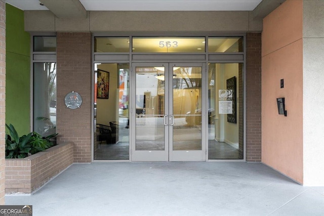 property entrance with brick siding and french doors