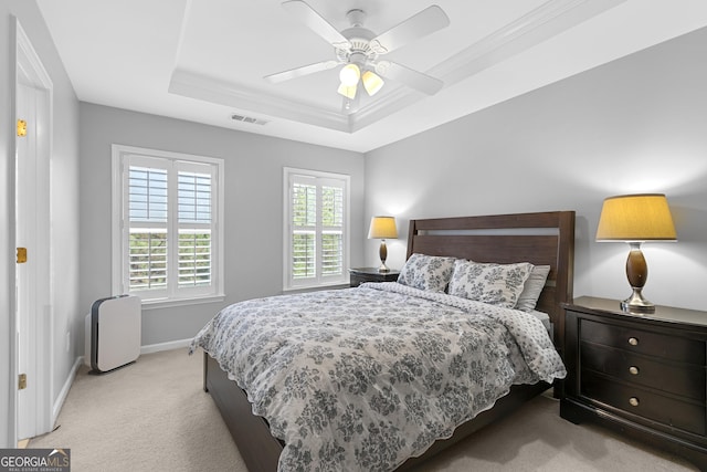 bedroom featuring ceiling fan, a raised ceiling, and light carpet