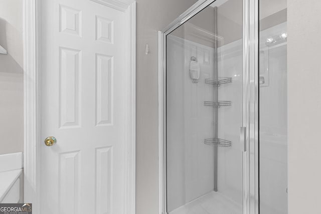 bathroom featuring a shower with shower door