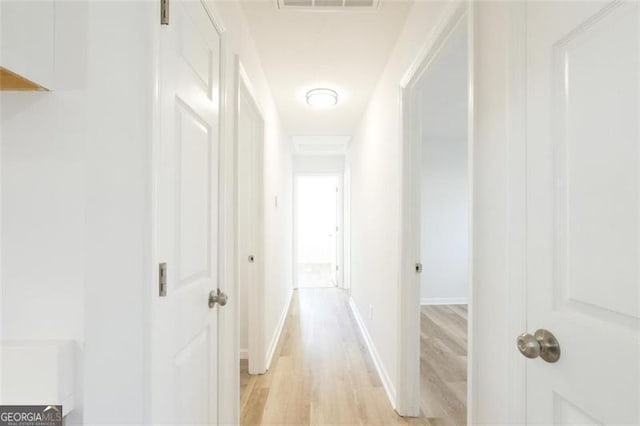 hallway with light hardwood / wood-style flooring