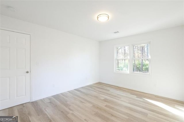 empty room with light hardwood / wood-style flooring