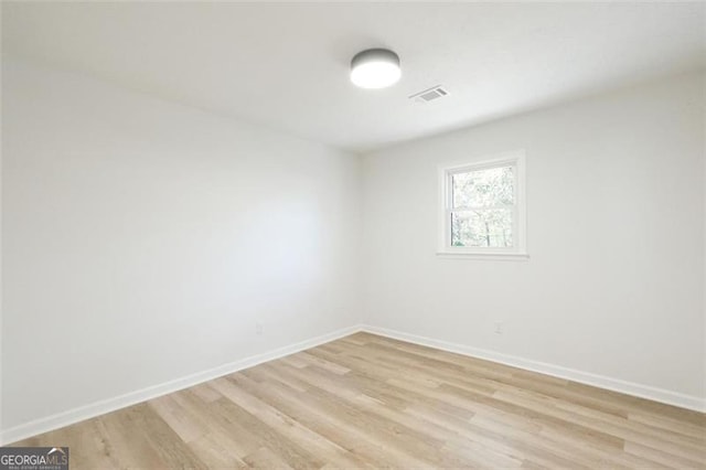 spare room with light hardwood / wood-style floors