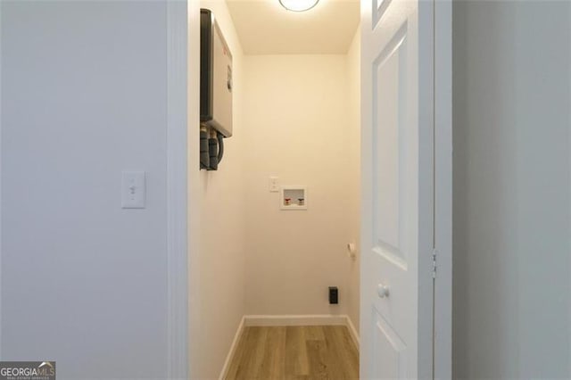 laundry area with hardwood / wood-style flooring and washer hookup