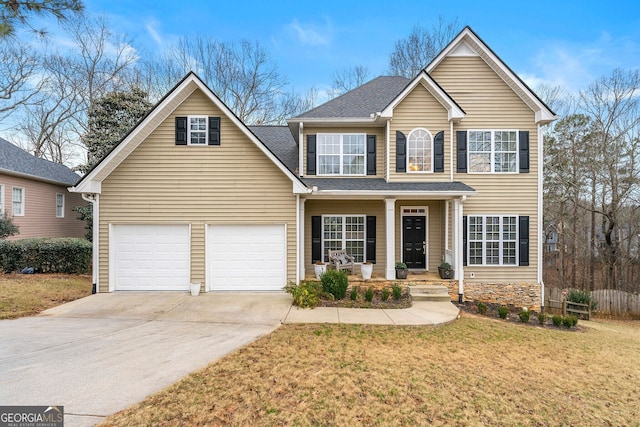 view of front property with a garage, a front lawn, and a porch