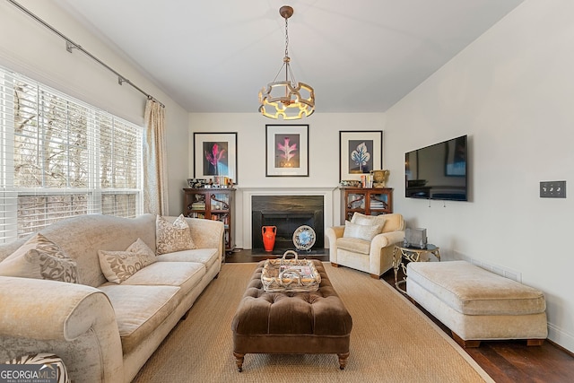 living room with wood-type flooring and a notable chandelier