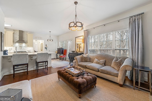 living room featuring a chandelier and dark hardwood / wood-style flooring