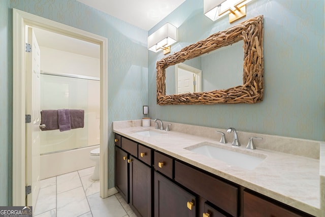 full bathroom featuring vanity, toilet, and combined bath / shower with glass door