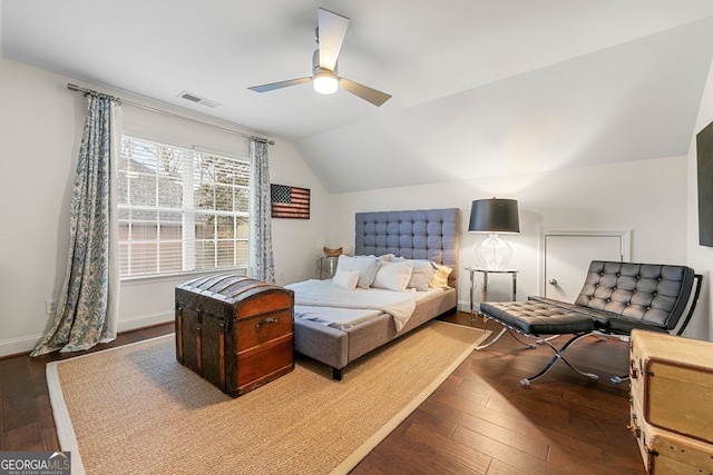 bedroom featuring dark hardwood / wood-style flooring, lofted ceiling, and ceiling fan