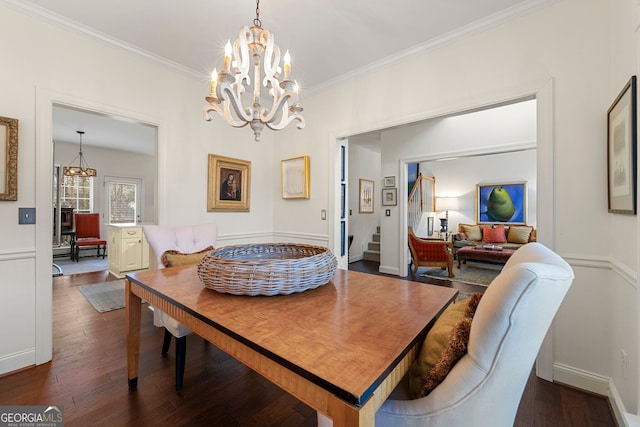 dining room with crown molding, dark hardwood / wood-style floors, and a chandelier