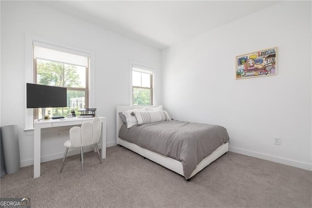 bedroom featuring light carpet