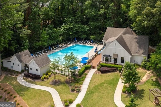 view of pool featuring a lawn