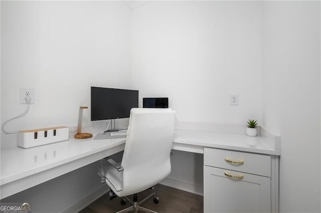 office with wood-type flooring and built in desk