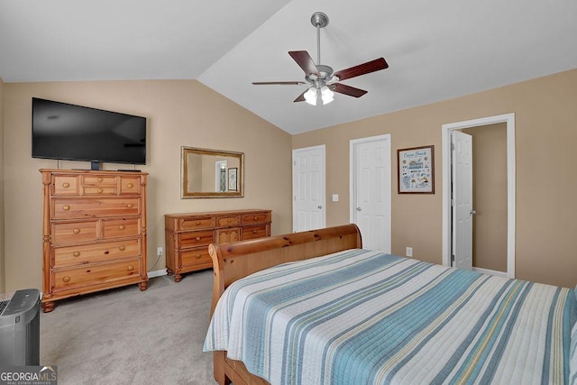 bedroom with lofted ceiling, light colored carpet, and ceiling fan