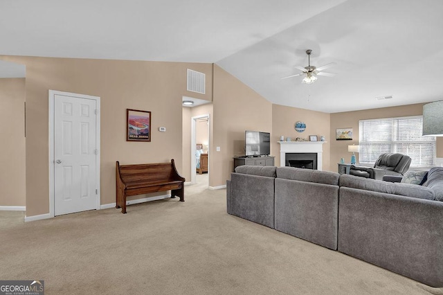 carpeted living room featuring vaulted ceiling and ceiling fan