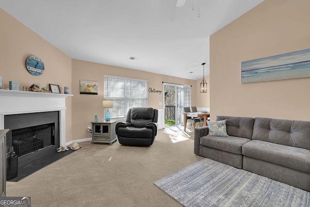 carpeted living room with vaulted ceiling