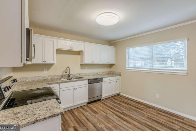 kitchen with sink, light wood-type flooring, appliances with stainless steel finishes, light stone countertops, and white cabinets