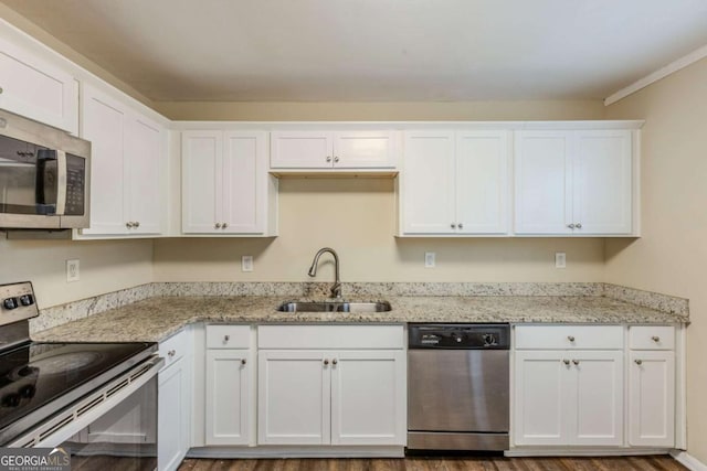 kitchen featuring appliances with stainless steel finishes, sink, and white cabinets