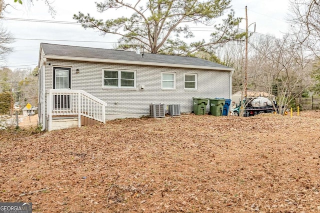 rear view of house with central air condition unit