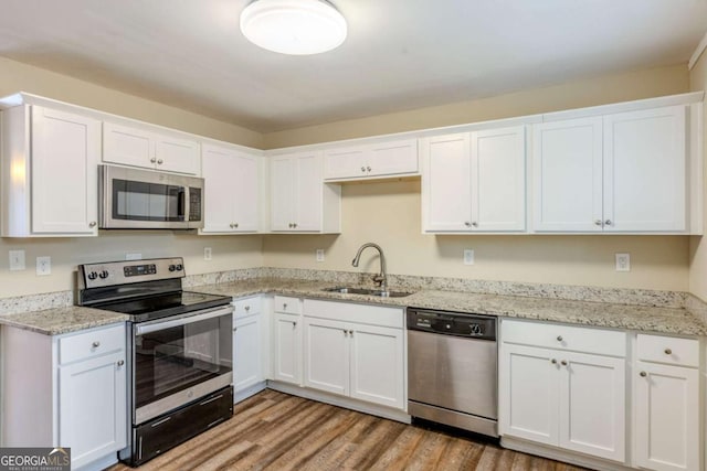 kitchen featuring white cabinetry, stainless steel appliances, and sink